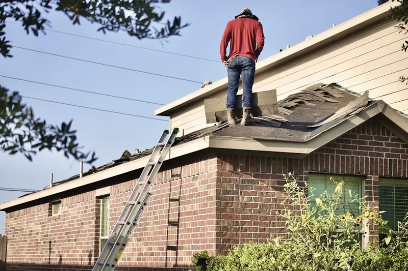 Professional roofer working on a residential roof in Cooper Village